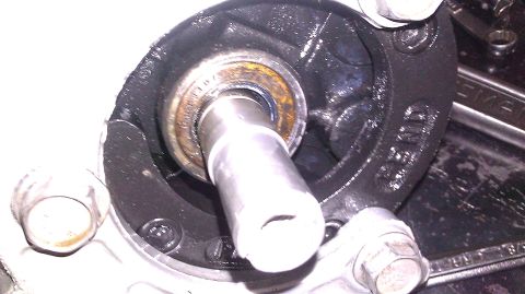 1996 Ford Bronco - A close-up view of a bearing and shaft assembly, likely part of a vehicle's drivetrain or suspension, with visible rust on the bearing.