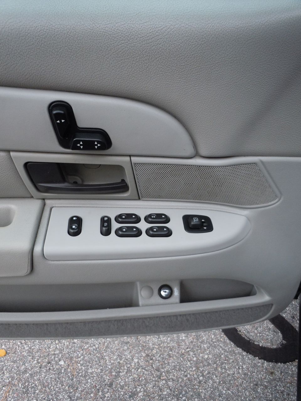 2001 Ford Crown Victoria interior door panel with power window and seat controls.