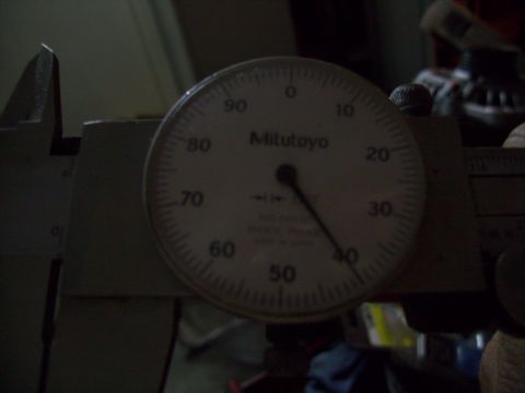 1995 Ford Probe - A close-up view of a Mitutoyo dial indicator gauge, likely used for precise measurements on a vehicle part. The gauge is mounted on what ap…