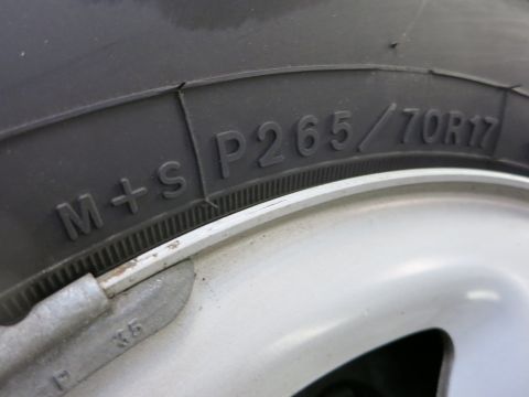 1991 Ford LTD Crown Victoria - Photograph of a tire sidewall with the molded size P265/70R17, not a technical document.