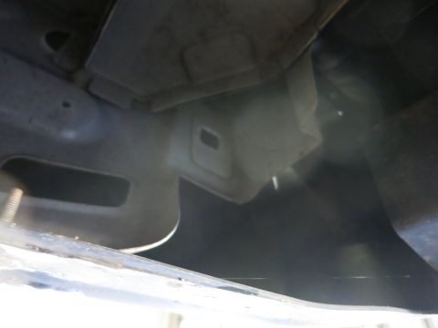 1991 Ford LTD Crown Victoria - Photograph looking up at a vehicle's underbody and frame, not a technical document.