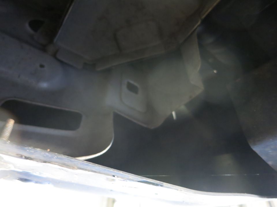 Dark underbody photo of a vehicle's undercarriage components