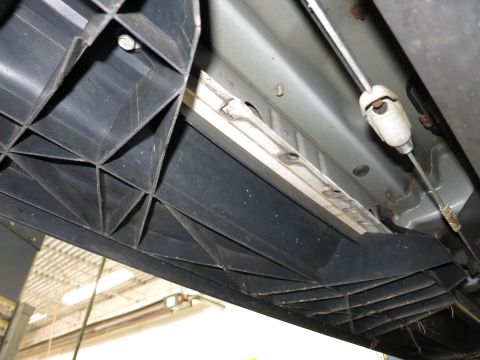 1991 Ford LTD Crown Victoria - Photograph of a vehicle's underside showing a side step and rocker panel, not a technical document.