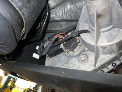 1991 Ford LTD Crown Victoria - Photograph of a vehicle transmission and connector harness with a parts tag, not a technical document.