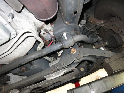 1991 Ford LTD Crown Victoria - Photograph of a vehicle's front underbody suspension and crossmember, not a technical document.