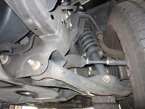 1991 Ford LTD Crown Victoria - Photograph of a vehicle's front suspension and steering rack, not a technical document.