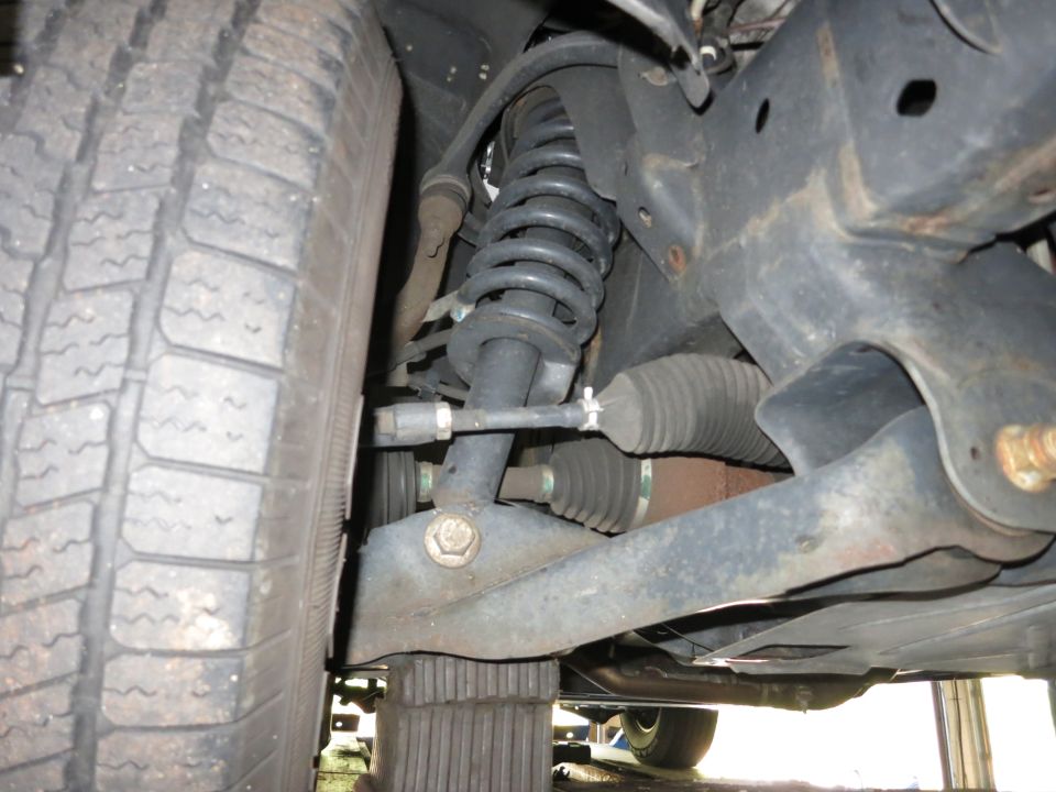 Underbody photo of coil-over shock, steering rack boots and control arm