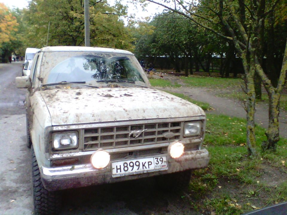 Dirty white 1988 Ford Bronco II parked on a dirt road.