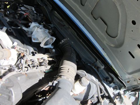 2001 Ford Crown Victoria - The engine bay of a 2001 Ford Crown Victoria is shown with the hood open, revealing various engine components and wiring harnesses.