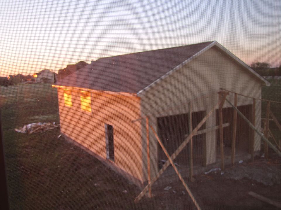 Partially constructed garage building at dusk