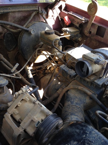 1996 Ford Bronco - Close-up view of various engine components, including the brake booster and master cylinder.