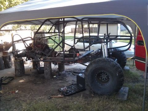 1986 Ford Bronco - Custom off-road vehicle frame under construction, showing engine and suspension parts.