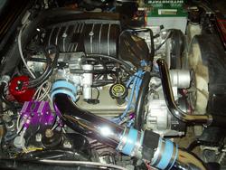 1993 Ford Mustang - Close-up view of a modified engine bay, showing various aftermarket components and wiring.