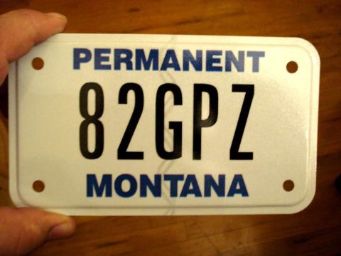 2008 Ford Crown Victoria - A Montana license plate with the characters 82GPZ is held by a hand. The plate reads PERMANENT and MONTANA.