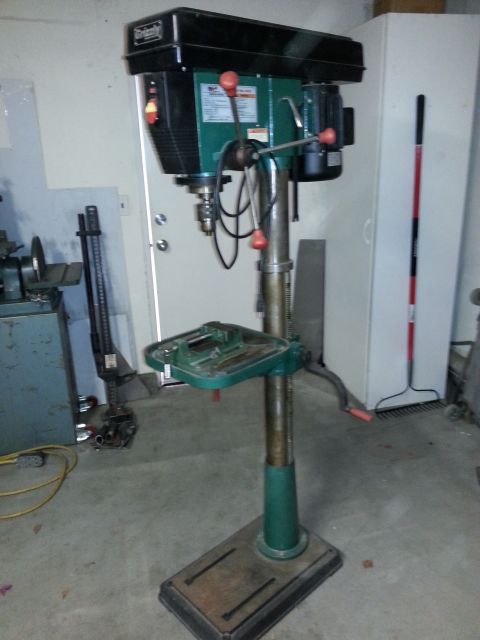 1997 Ford Ranger - A drill press stands in a garage, with tools and cabinets visible in the background.