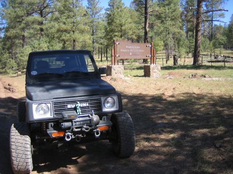 1987 Suzuki Samurai - Suzuki Samurai parked in a wooded area near a sign for Rogers Lake County Natural Area.