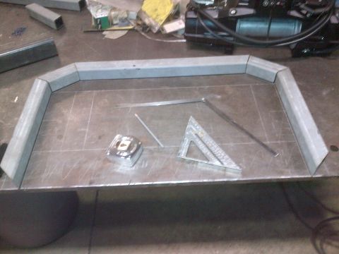 1985 Jeep CJ7 - Metal fabrication in progress on a workbench, with tools laid out.