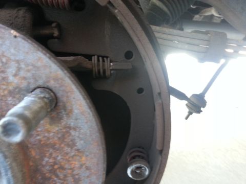 1994 Ford Bronco - Close-up of a vehicle's rear drum brake assembly, showing internal components and wear.