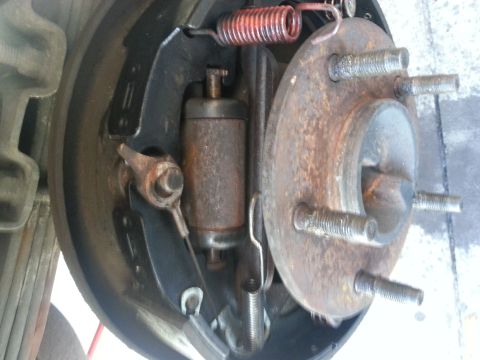 1994 Ford Bronco - Close-up view of a rear drum brake assembly, showing the brake shoes, springs, and wheel cylinder.