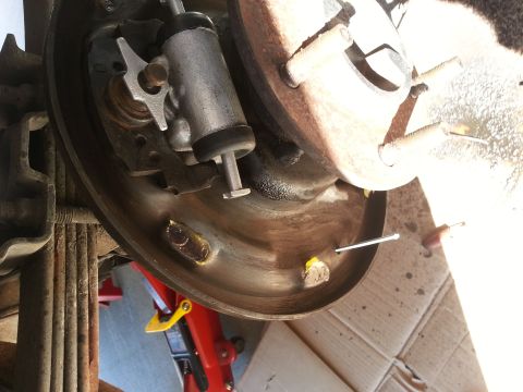 1994 Ford Bronco - Close-up of a vehicle's rear drum brake assembly, showing internal components.