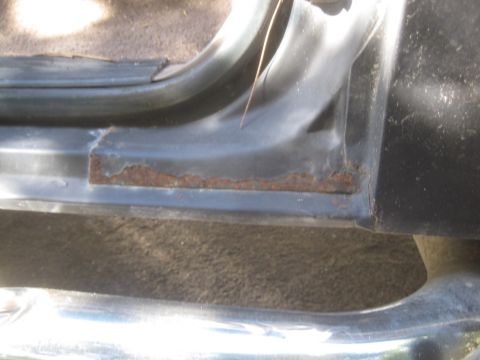 1993 Ford Bronco - The lower door frame shows significant rust damage, indicating potential structural issues.