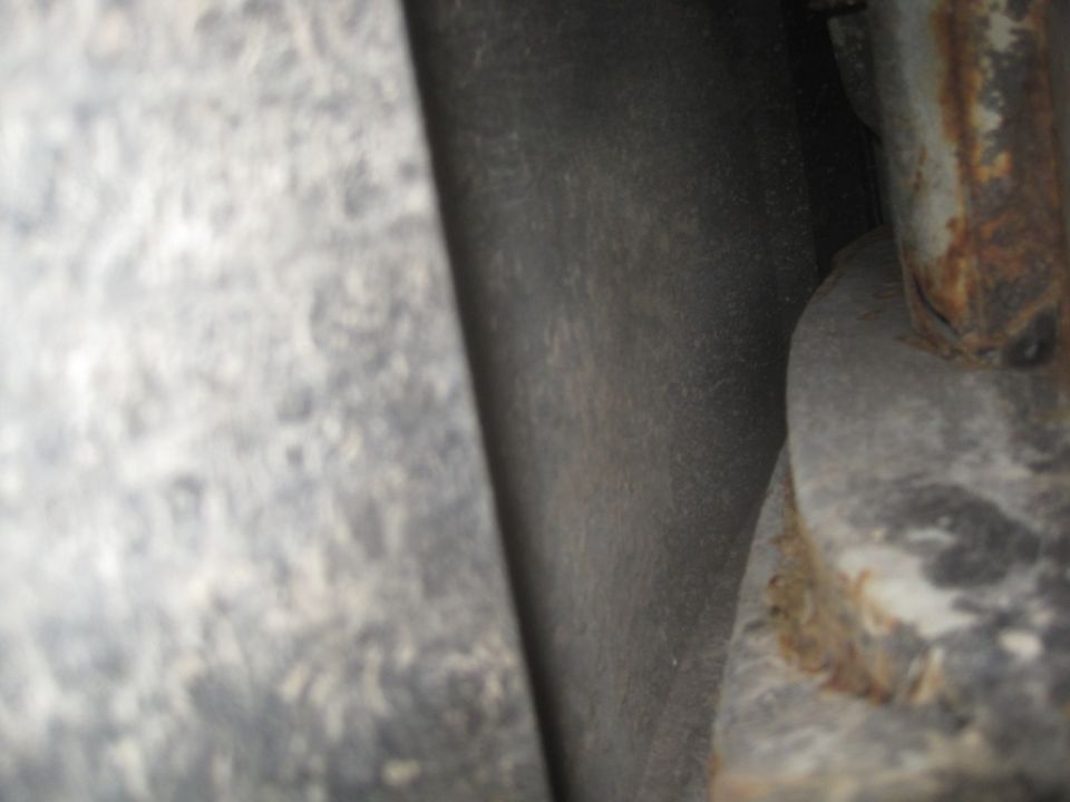 Close-up of rusted metal components, possibly from a vehicle's undercarriage