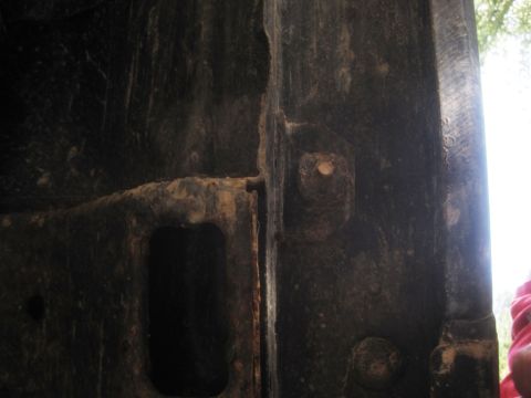 1993 Ford Bronco - Close-up of a heavily rusted metal frame part, likely from a vehicle's undercarriage.