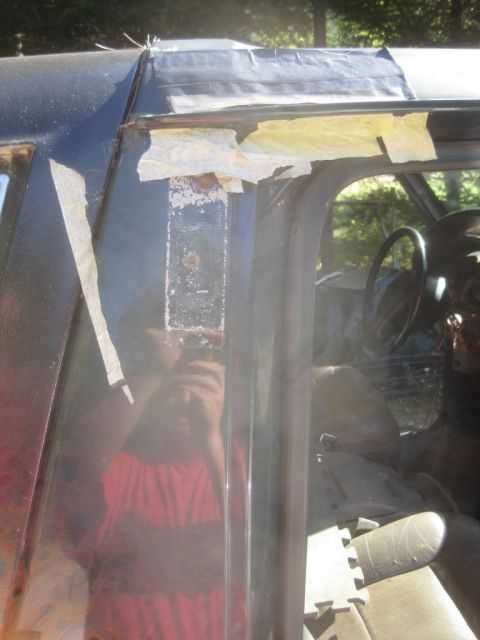 1993 Ford Bronco - Interior view of a vehicle, showing tape on the door frame and a reflection.