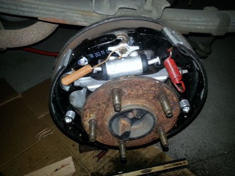 1994 Ford Bronco - Rear drum brake assembly showing shoes, springs, and wheel cylinder. Part number TR 263 FF 01 is visible.