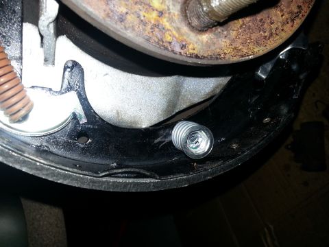 1994 Ford Bronco - Close-up view of a vehicle's rear drum brake assembly, showing brake shoes and hardware.