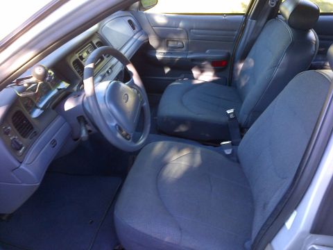 2001 Ford Crown Victoria - Interior of a 2001 Ford Crown Victoria, showing the driver's side dashboard and front seats.