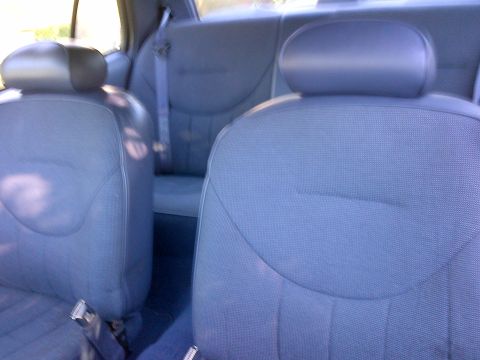 2001 Ford Crown Victoria - Interior view shows front and rear seats with seatbelts.