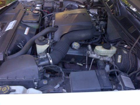2001 Ford Crown Victoria - The engine bay of a vehicle is shown from a top-down perspective.