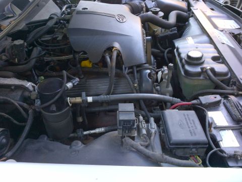 2001 Ford Crown Victoria - Close-up view of a vehicle's engine bay, showing various components including the battery and fuse box.