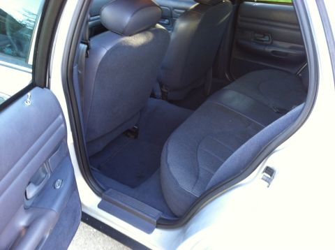 2001 Ford Crown Victoria - Rear interior view of a 2001 Ford Crown Victoria, showing the blue cloth seats and door panel.