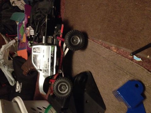 1995 Ford F-150 - An RC car is shown on its side, surrounded by various household items and debris.