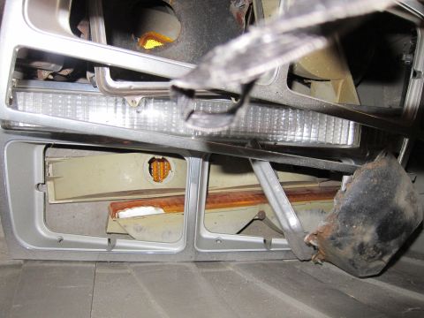 1991 Ford LTD Crown Victoria - The disassembled front end of a vehicle shows multiple light components, including turn signals and brake lights.