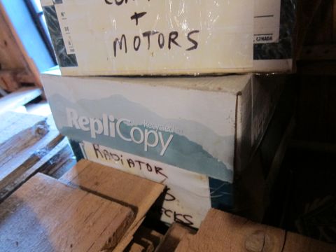 1991 Ford LTD Crown Victoria - Photograph of storage boxes with handwritten part labels, not a technical document.