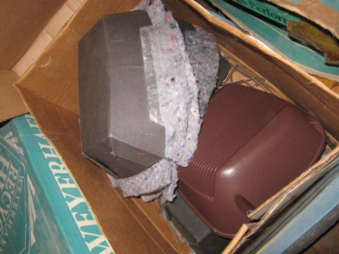 1991 Ford LTD Crown Victoria - Contents of a cardboard box include insulation and a brown plastic part.