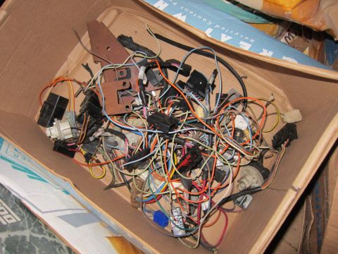 1991 Ford LTD Crown Victoria - A box contains a jumble of automotive electrical wiring and connectors, likely for parts or repair.