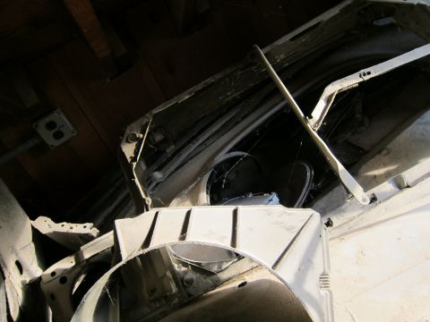 1991 Ford LTD Crown Victoria - Disassembled car parts, likely from a large sedan, are stored in a dusty indoor space.