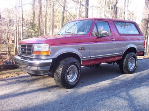 1995 Ford Bronco - This 1995 Ford Bronco is shown in a three-quarter front view, a two-tone red and silver paint scheme.