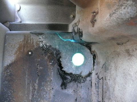Close-up of corroded metal with a bright circular light