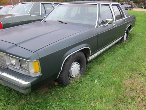 1991 Ford LTD Crown Victoria - Front quarter view of a 1991 Ford Crown Victoria LTD parked on a grassy area.