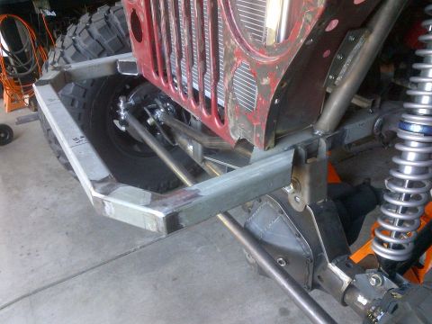 1985 Jeep CJ7 - This Jeep's front end is undergoing significant modification, with custom fabrication visible around the grille and suspension.