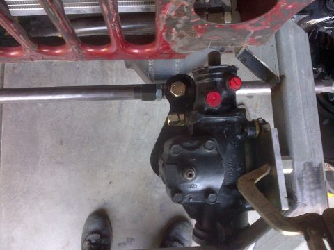 1985 Jeep CJ7 - Close-up view of the steering box and linkage assembly, with part of the grille visible above.