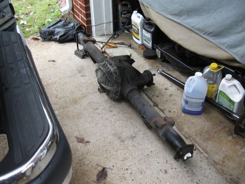 1994 Ford Bronco - A disassembled rear axle assembly sits on the ground, possibly awaiting installation or repair.