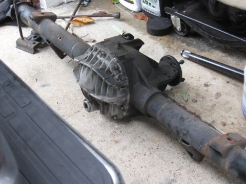 1994 Ford Bronco - A rear axle assembly is shown, likely a Ford 9-inch rearend, on a concrete surface.