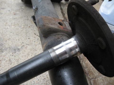 1994 Ford Bronco - Close-up view of a rear axle assembly, highlighting a machined surface for a bearing.