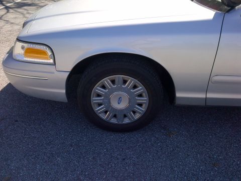2001 Ford Crown Victoria - Front passenger side fender and wheel of a silver 2001 Ford Crown Victoria.